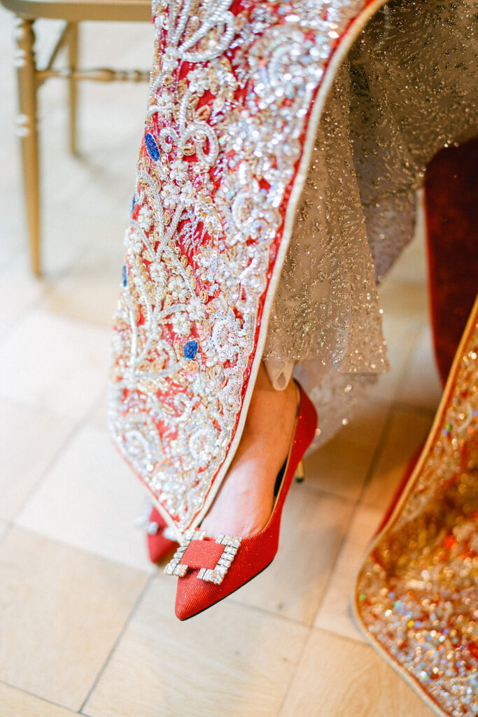 Bride wearing red crystal-embellished heels and an intricately beaded red qipao at her Luxembourg wedding