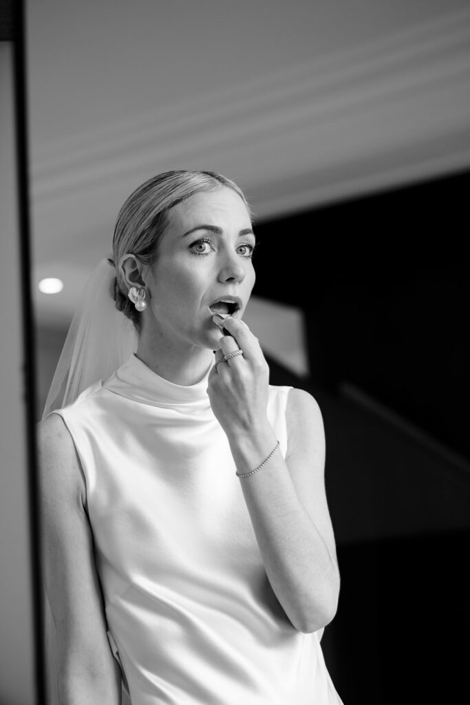 Bride Carla getting ready in her minimalist silk wedding gown at Château de Mirwart Belgium black and white