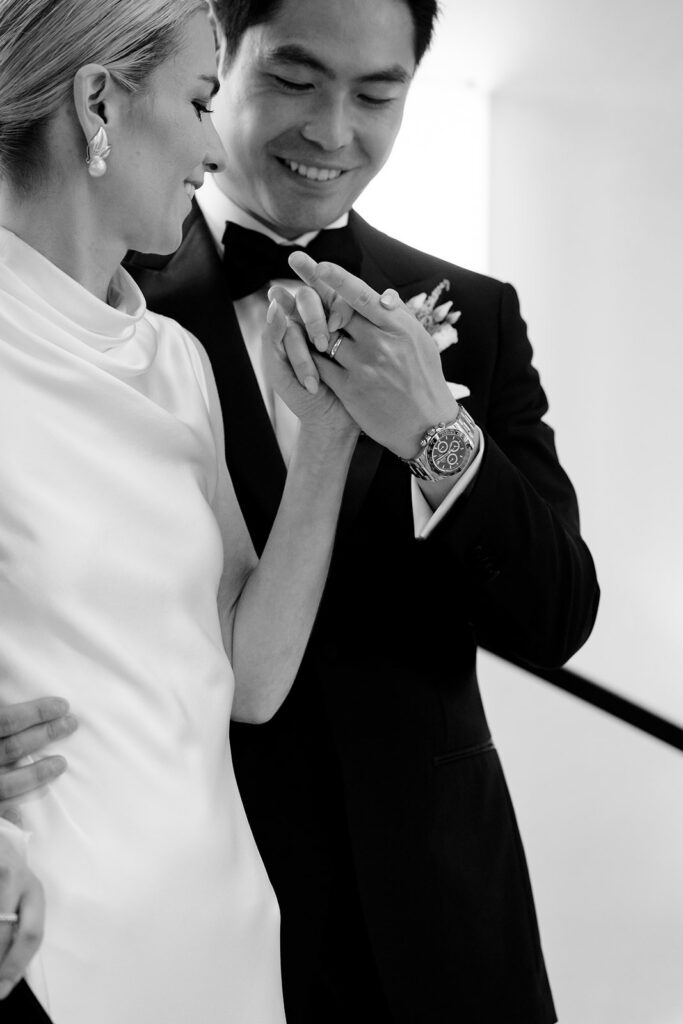 Close up black and white portrait of Carla and Robin holding hands and laughing together on their wedding day at Château de Mirwart Belgium