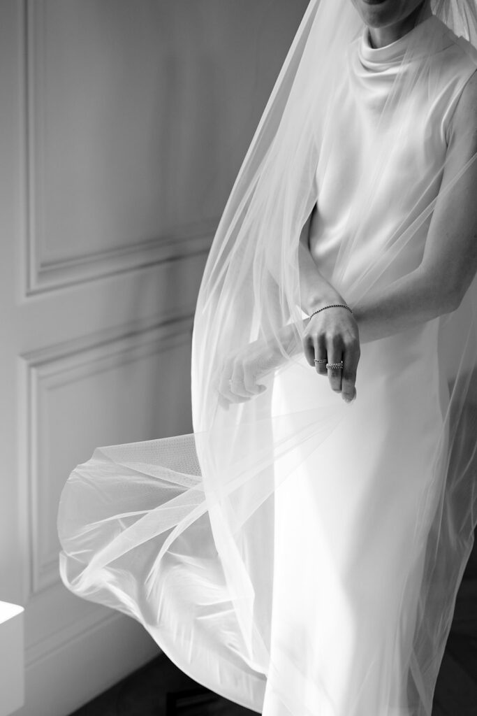 Bride Carla getting ready at Château de Mirwart in her elegant silk bridal gown and veil on her wedding morning