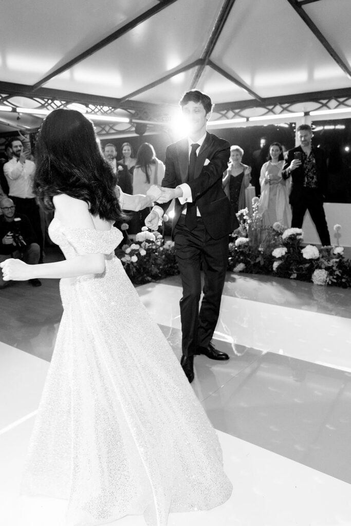 Black and white photo of Crystal and Cobi sharing their first dance in Crystal's sparkly reception dress at their Villa Cimbrone wedding reception in Ravello Italy