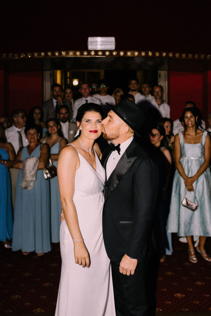 Bride and groom making their entrance into the evening wedding party at Château du Bois d'Arlon Belgium surrounded by guests in the ballroom