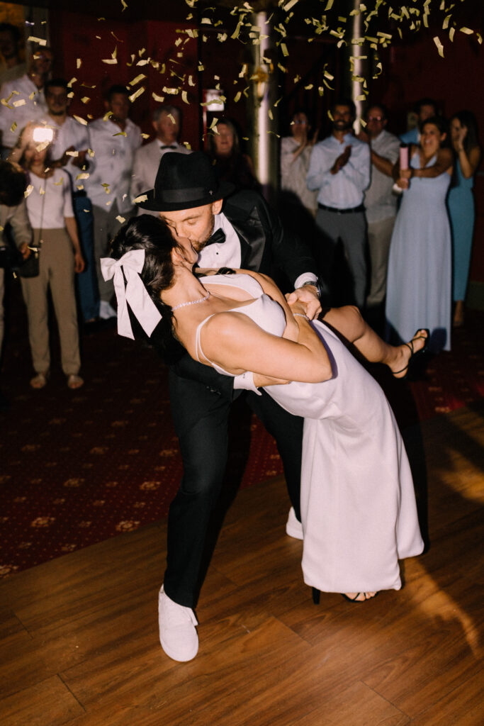 Bride in her second dress being dipped by the groom during their first dance at the Château du Bois d'Arlon wedding party in Belgium