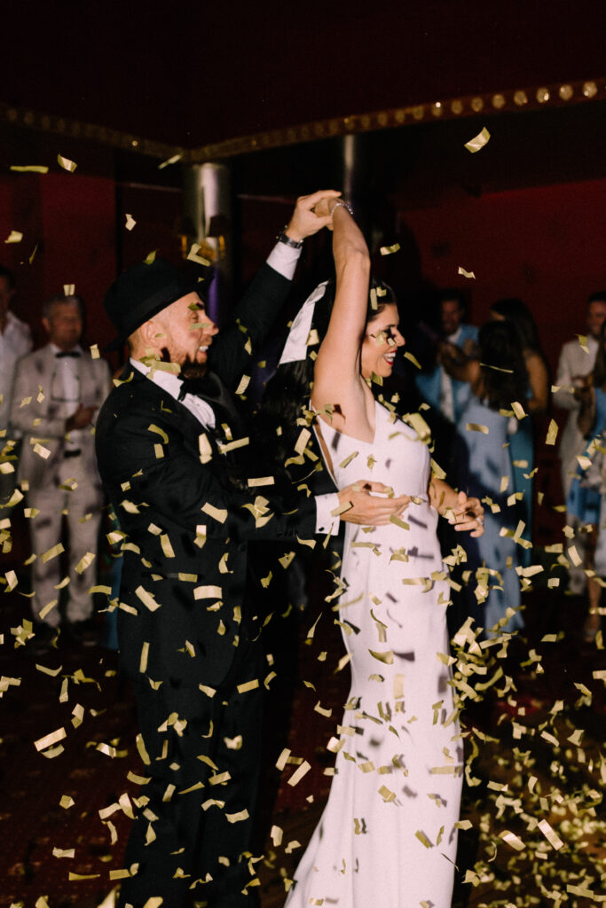 Bride and groom dancing under a shower of gold confetti at the Château du Bois d'Arlon wedding reception party in Belgium