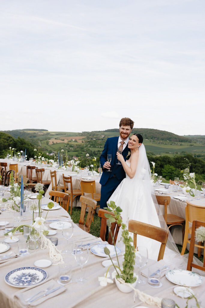 Hazelnut House 1851 Luxembourg wedding reception, the bride and groom sharing a quiet moment beside the candlelit banquet table overlooking the green valley